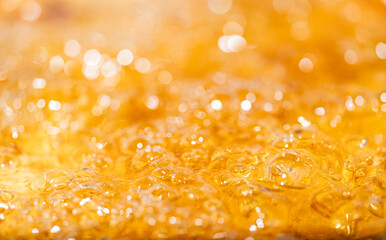 Close up bright orange Oil or beer splash texture and nature waves, Beautiful waves curve and little bubbles smooth for graphic design and background, Oil Bubbles, Soft beer bubbles, Selective focus