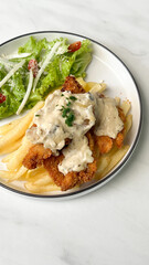 classic traditional italian chicken parmigiana with cheese, tomato sauce meal and french fries