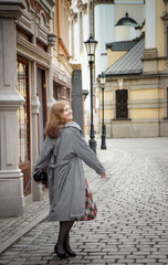 young beautiful woman in vintage suit in european city