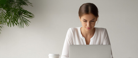 Businesswoman laptop office workspace professional woman working coffee plant white modern desk technology concentration corporate female adult job workplace success career confident computer