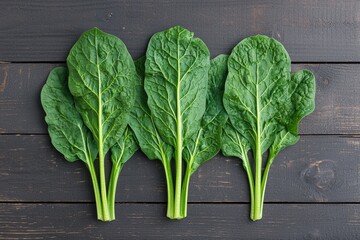 Fototapeta premium Fresh spinach leaves arranged on rustic wooden table promoting healthy eating