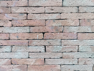 Brick wall conveys sense of rustic charm. varying hues and textures of bricks create vintage and weathered aesthetic, creating cozy atmosphere