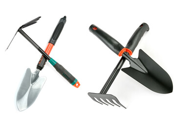 Garden shovel and rake isolated on white background.