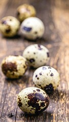 Obraz premium A rustic wooden table displays a variety of quail eggs, showcasing their speckled shells in earthy tones, surrounded by soft natural light.