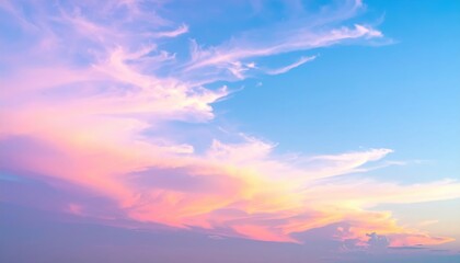 Obraz premium A vast expanse of clear blue sky stretches overhead, with soft, fluffy white clouds scattered like cotton candy, creating a serene and tranquil atmosphere.