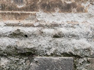 Weathered stone wall texture with cracked cement details