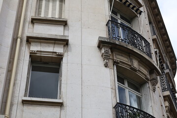 Architectural elegance of a historic apartment building featuring intricate details and balconies in an urban setting