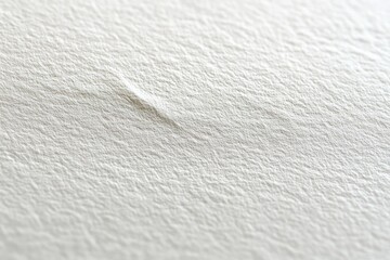 Close-up of a textured white paper surface with a subtle crease and soft lighting creating gentle shadows
