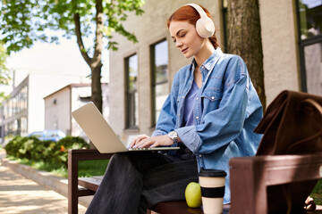 Red haired woman enjoys a peaceful moment working outdoors while listening to music