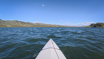 kayaking or canoeing on windy Horsetooth Reservoir near Fort Collins, Colorado - POV paddler...
