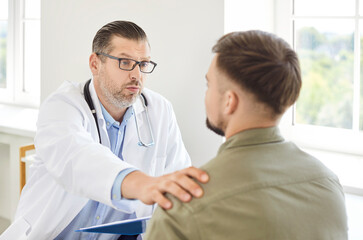 Fototapeta premium Doctor or nurse in communication and talking with a patient, providing medical support and advice in a hospital setting. Healthcare professional ensures the patient receives proper care and guidance.