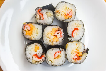 close up of several pieces of sushi on a plate