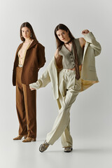 Stylish twin sisters embody elegance and creativity in contemporary fashion setting