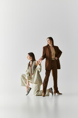 Stylish twin sisters showcasing unique fashion in a creative studio setting