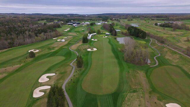 Aerial wide shot of TPC Toronto at Osprey Valley Golf Course In Alton Town, Caledon, Ontario, Canada. Neat grass and lawn of golf course. Wide shot.