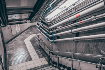 Obraz premium Dec 8 2024 Industrial Staircase with Metal Pipes in a Subway Passageway, tokyo