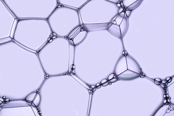 Macro photo of soap bubbles on a violet background