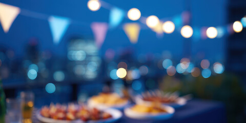 Rooftop party with small flags and grilled food under string lights