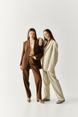 Fototapeta premium Stylish twin sisters showcase their unique fashion sense in a captivating studio setting
