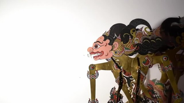 Close Up Of Intricate Traditional Shadow Puppet Against White Background