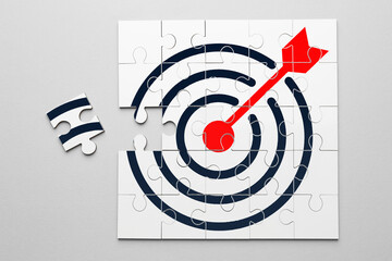 Targeting. One puzzle piece missing to make image of bullseye on light background, top view