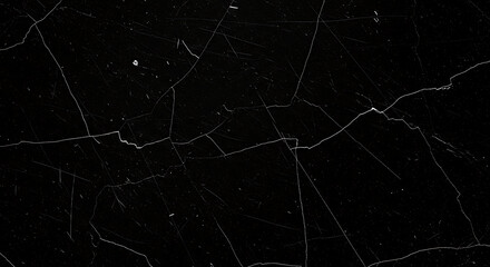 Intricate network of pale fractures traversing a stark black background