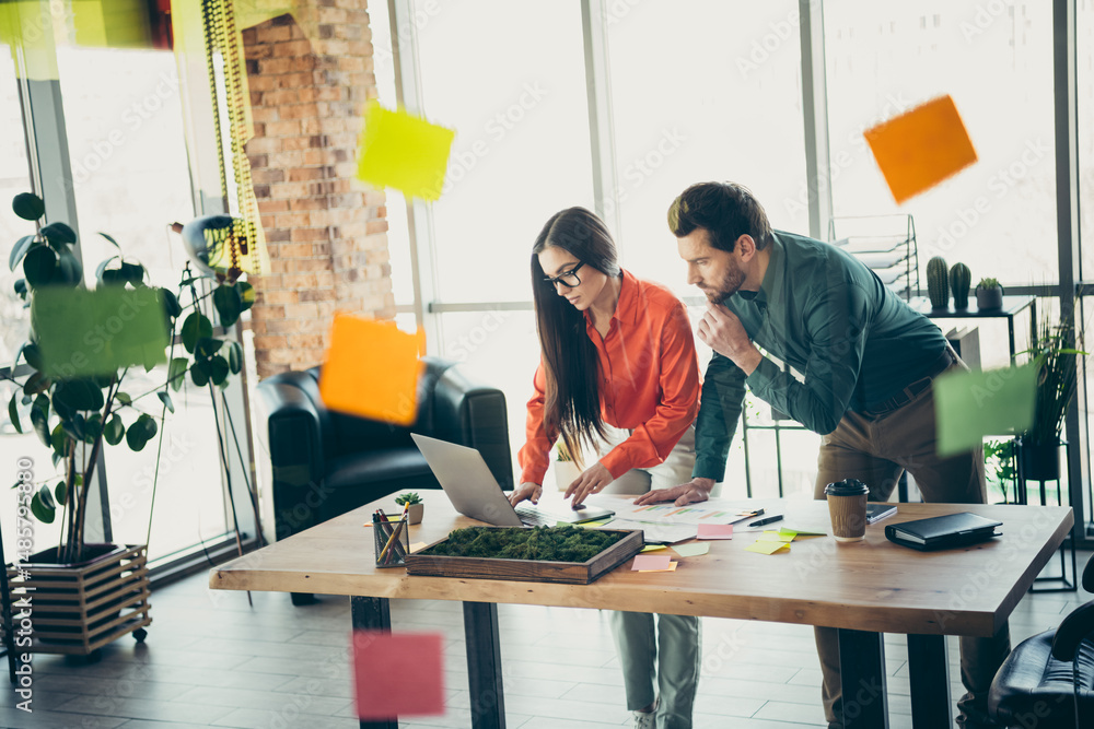 Poster professional coworkers collaborating on a startup project in a modern office setting with sticky not