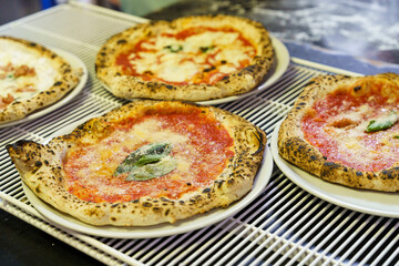 Freshly baked Neapolitan pizzas on plates