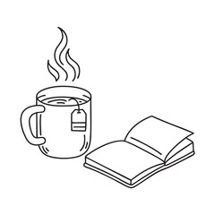 A tea bag steeping in a mug near an open notebook
