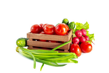 Tomatoes, radishes, green onions, cucumbers and lettuce in a wooden box. Isolated on white background.