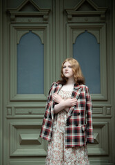 young beautiful woman in vintage suit in european city