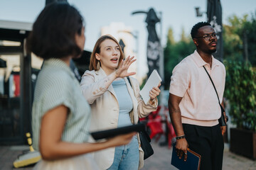 A diverse group of people engage in an outdoor meeting, showcasing teamwork and collaboration in a business setting. The team discusses strategies and innovations in a relaxed environment.
