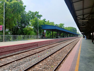 Empty Railway Station Platform with Train Tracks and Canopy in Daylight Photography