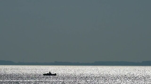Idyllic shot of the Schaproder Bodden: The shimmering water reflects the blue sky. Boats float by, creating a relaxed atmosphere. Video excerpt 24 sec, 117 MB, rate is 50 pps.