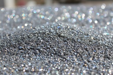 A close up of a pile of silver glitter on a table