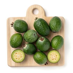 Overhead view of ripe feijoa fruits with halves on a wooden board