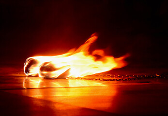 burning balls with chains for a fire show lie on the floor

