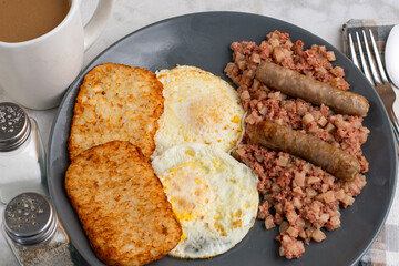 eggs ove easy  with corn beef hash and sausage