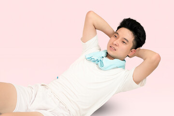 young man doing push up in pink background