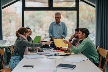 Students gather in a study session, receiving guidance from a senior professor. They collaborate on...