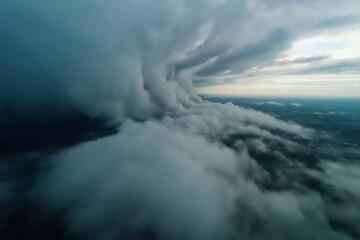 Drone capturing impressive storm clouds gathering over land, creating a dramatic and powerful scene