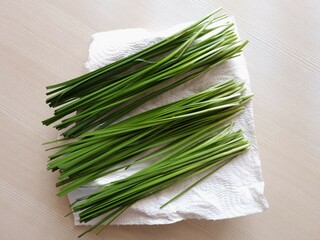 Bunch of fresh green onions. Bunches of green onions on a napkin in a plate