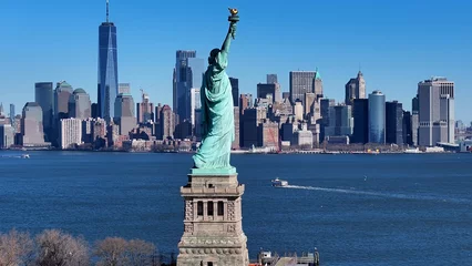 Fotobehang New York Liberty Statue At Manhattan In New York United States. Hudson River. Port Of New York Scene. Liberty Statue At New York United States. Boat Sailing Background.   © bydronevideos
