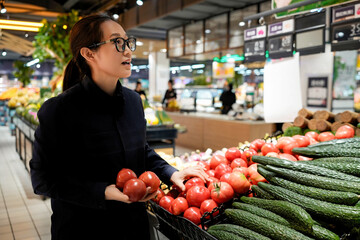 Woman Shopping for Tomatoes in a Supermarket