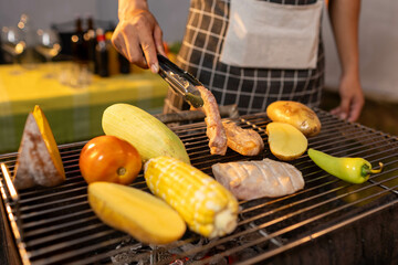A man enjoys a summer barbecue outdoors, grilling meat and vegetables over open flames, surrounded by friends, smoke, drinks, and weekend freedom.
