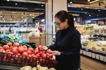 Woman Shopping for Tomatoes in Grocery Store