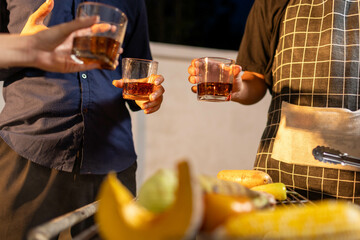 Friends gather indoors at a colorful bar, raising glasses in joyful celebration, enjoying drinks, laughter, and lively conversation in a vibrant, social atmosphere.