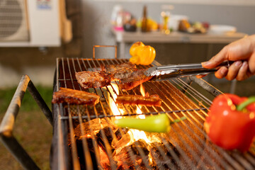 Juicy, tender steak sizzles over open flames on a rustic barbecue grill, with herbs and smoke enhancing the rich aroma of outdoor cooking.

