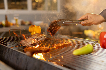 Juicy, tender steak sizzles over open flames on a rustic barbecue grill, with herbs and smoke enhancing the rich aroma of outdoor cooking.
