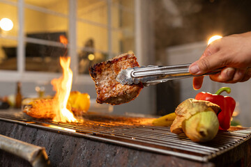Juicy, tender steak sizzles over open flames on a rustic barbecue grill, with herbs and smoke enhancing the rich aroma of outdoor cooking.
